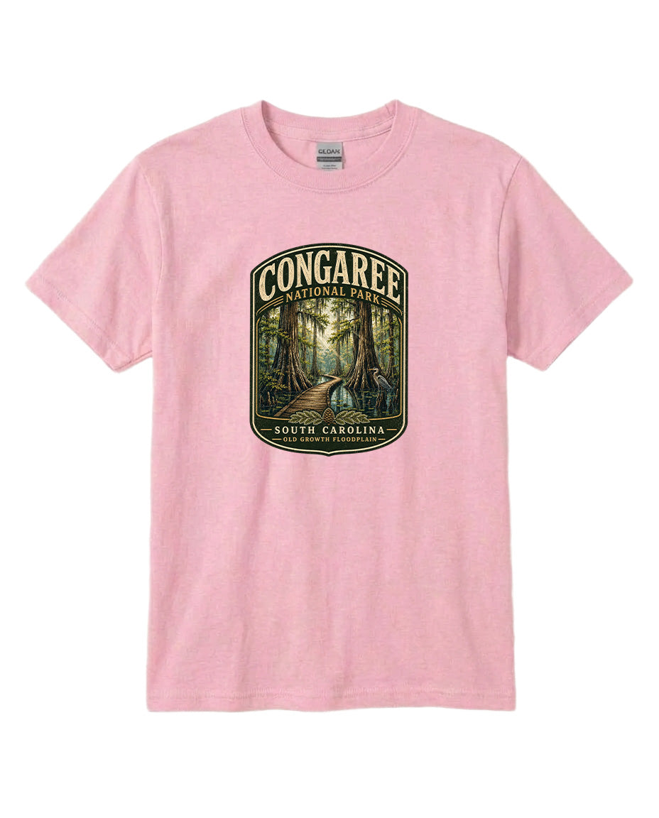 A pink t-shirt with a graphic design depicting a forest scene with a path leading through it, surrounded by trees.