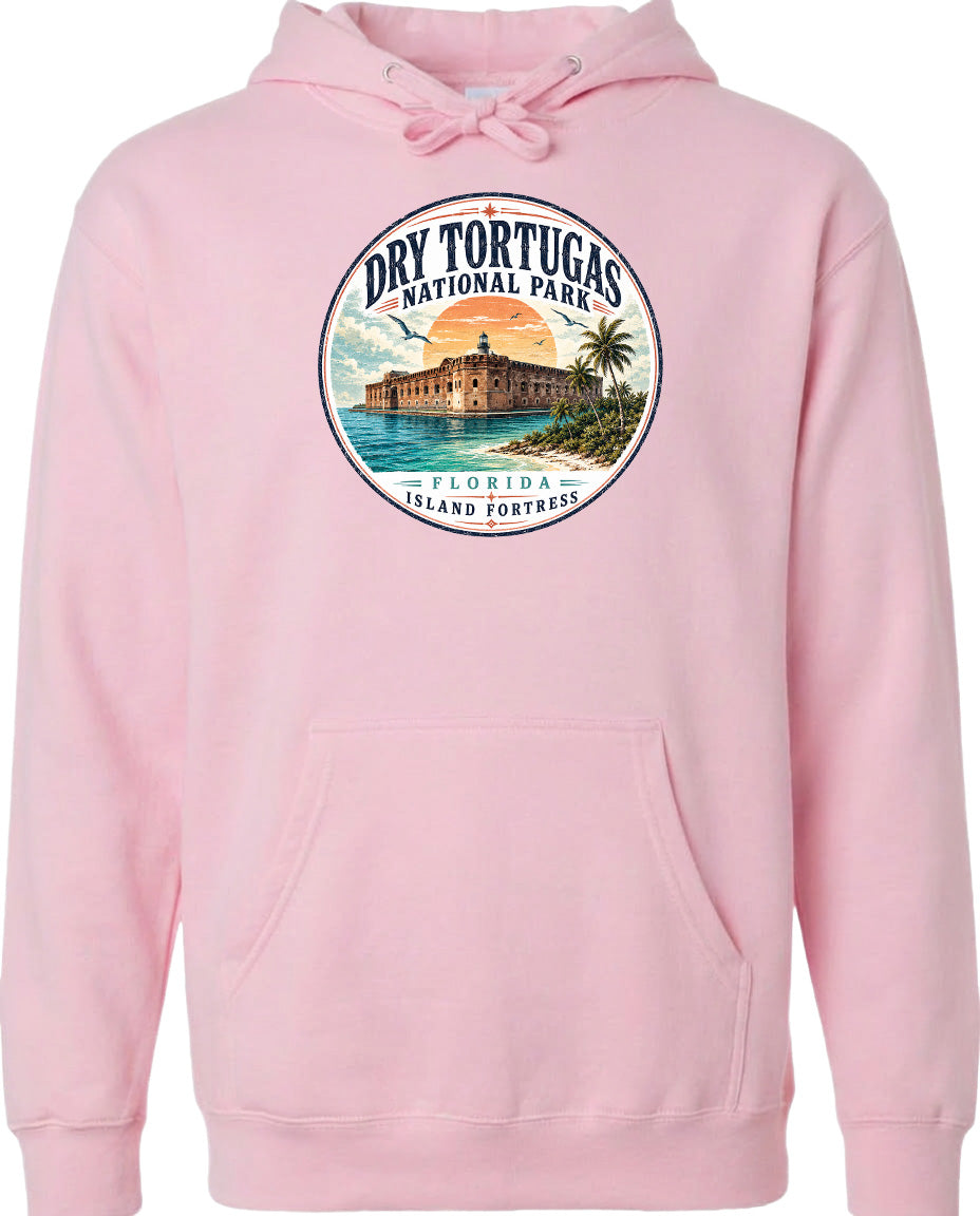A pink hoodie with a circular design featuring a tropical island and a building, along with the text "Dry Tortugas National Park, Florida Island Fortresses".