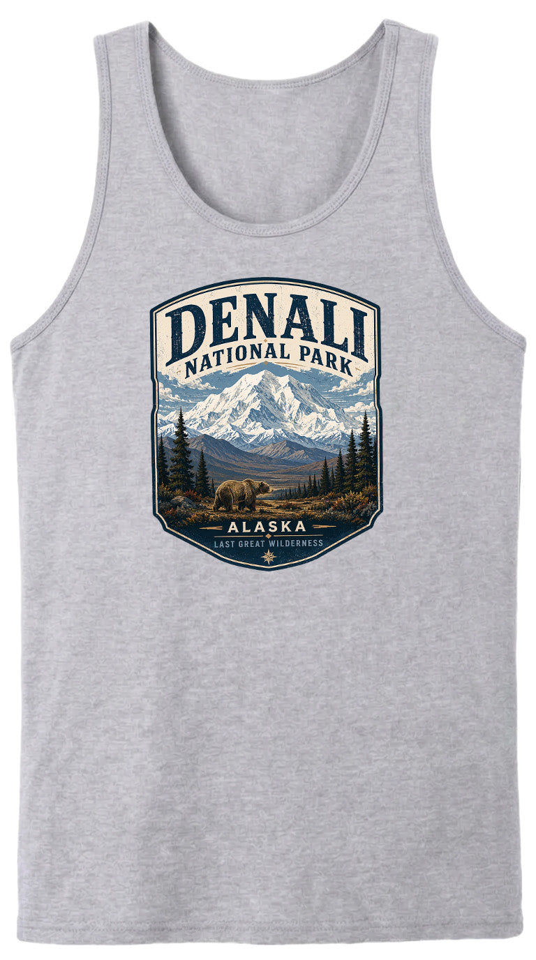 A gray tank top with a graphic design depicting a mountain landscape with a bear in the foreground, surrounded by pine trees and mountains.