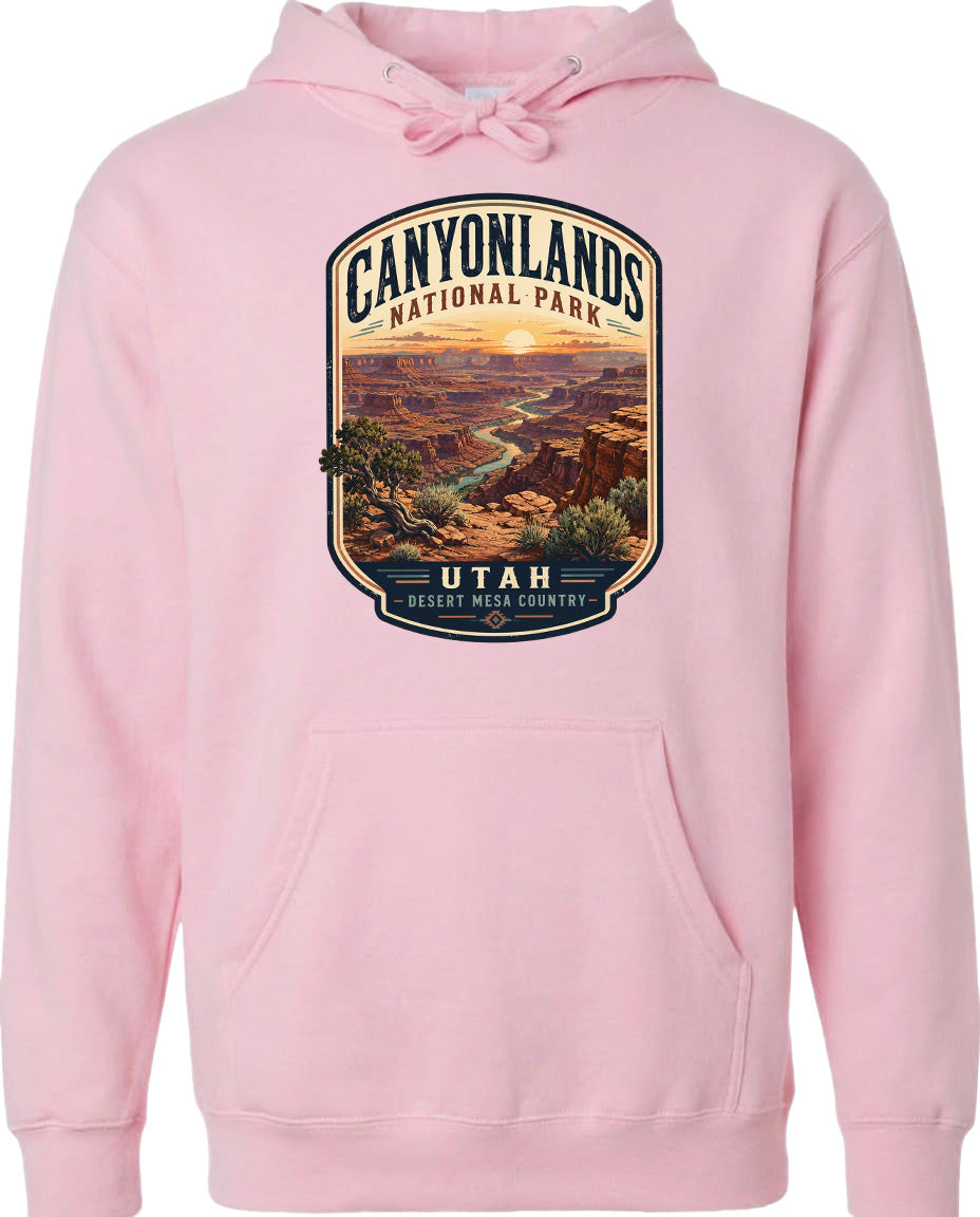 A pink hoodie with a graphic design depicting the scenic landscape of Canyonlands National Park in Utah.