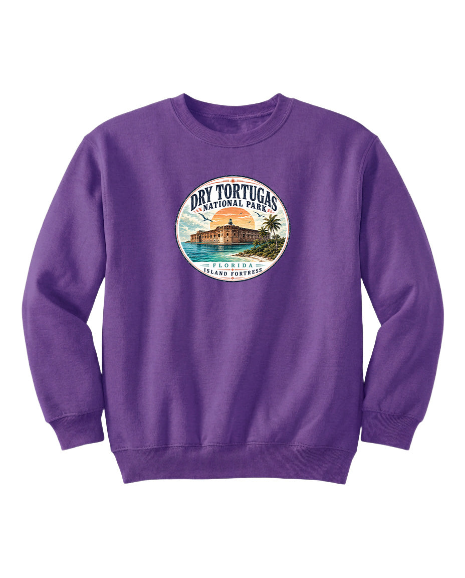 A purple sweatshirt with a circular graphic design featuring a beach scene and a building, representing Dry Tortugas National Park in Florida.