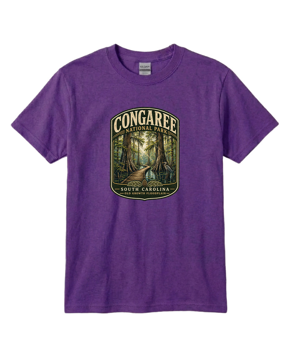 A purple t-shirt with a graphic design depicting a forest scene, featuring a path leading through the trees.