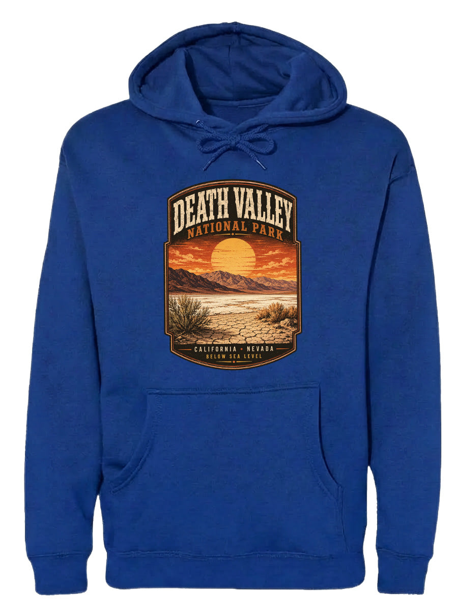 A blue hoodie with a graphic design depicting Death Valley National Park, including a sunset over the mountains and desert landscape.