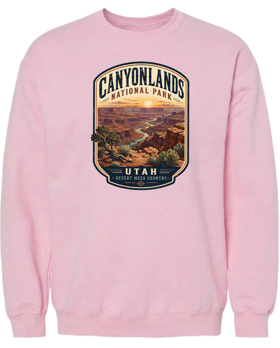 A pink sweatshirt with a graphic design depicting the Canyonlands National Park in Utah.
