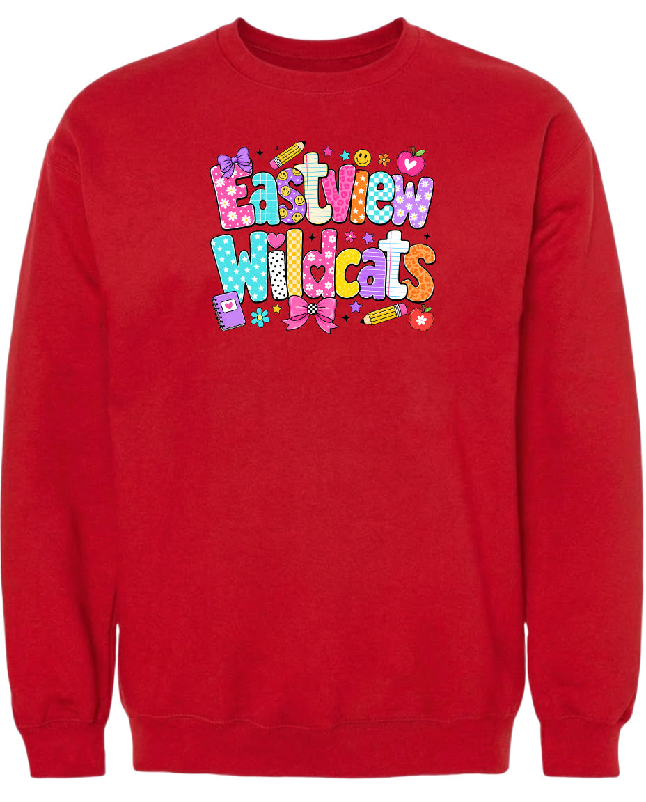A red sweatshirt with a colorful graphic design featuring the text "Eastview Wildcats" and various decorative elements such as flowers, hearts, and pencils.