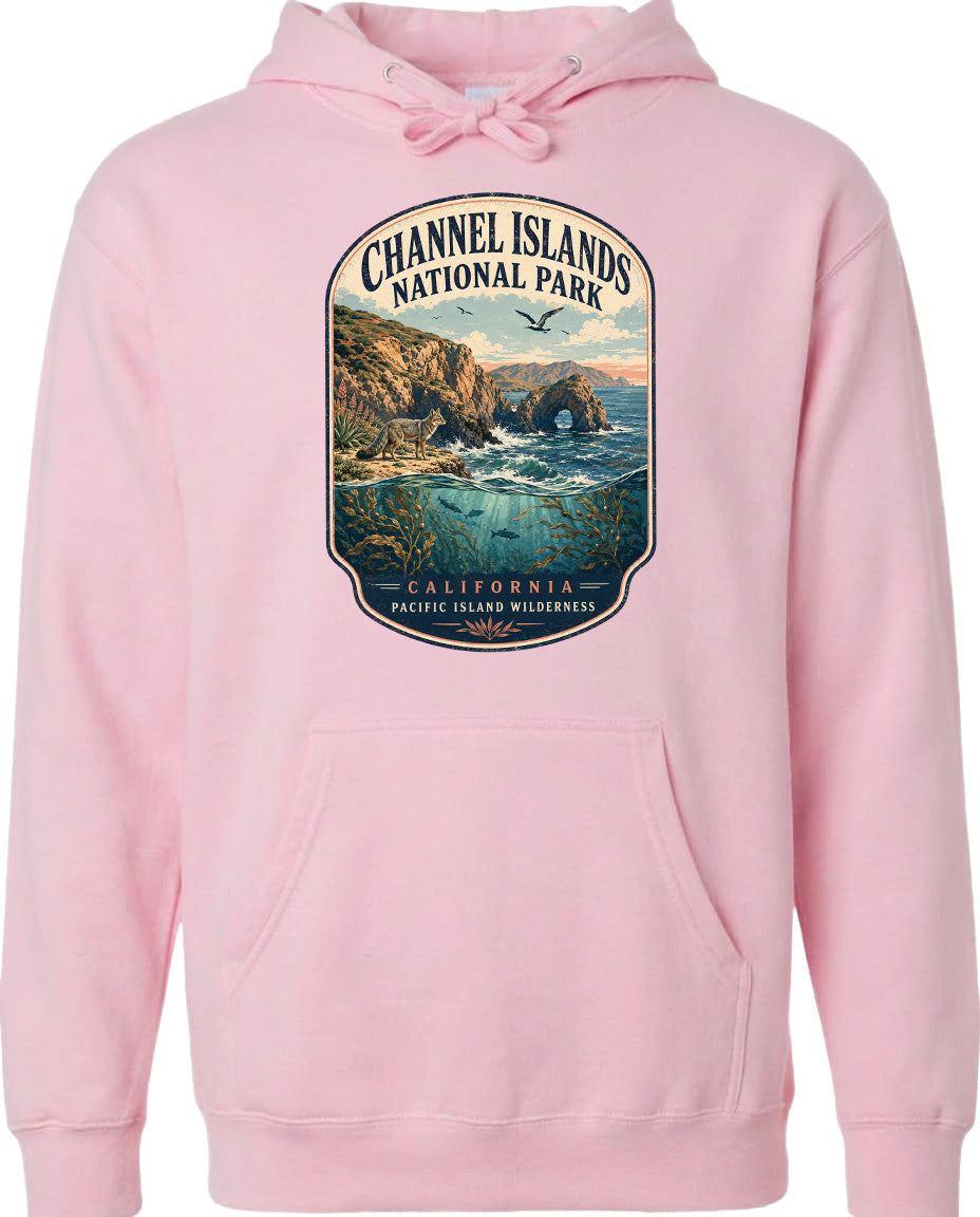 A pink hoodie with a graphic design depicting a scenic landscape, including a rocky coastline, ocean, and mountains, along with the text "Channel Islands National Park, California, Pacific Island Wilderness".