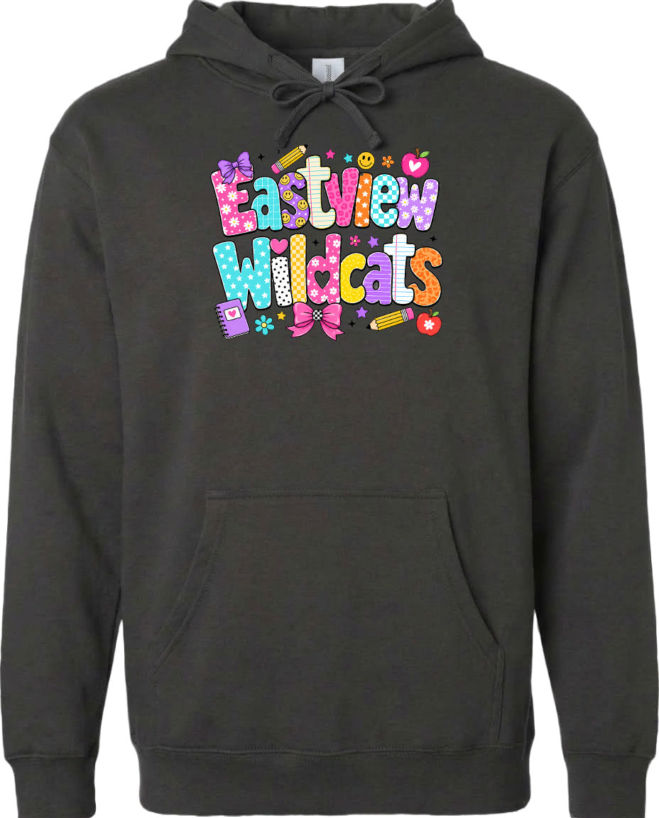 A black hoodie with a colorful graphic design featuring the text "Eastview Wildcats" and various decorative elements such as flowers, stars, and a pencil.