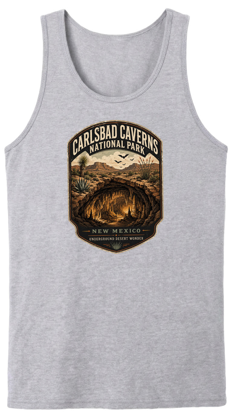 A gray tank top with a graphic design depicting the Carlsbad Caves National Park in New Mexico, featuring a desert landscape with a cave system and the text "CARLSBAD CAVENS NATIONAL PARK" and "UNDERGROUND DESERT WONDER".