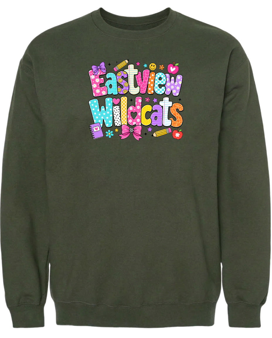 A dark green sweatshirt with a colorful graphic design featuring the text "Eastview Wildcats" and various decorative elements such as hearts, stars, and flowers.
