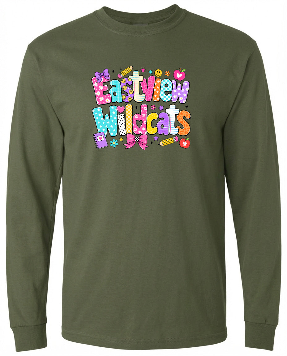 A long-sleeved olive green t-shirt with a colorful graphic design featuring the text "Eastview Wildcats" and various decorative elements such as hearts, flowers, and pencils.