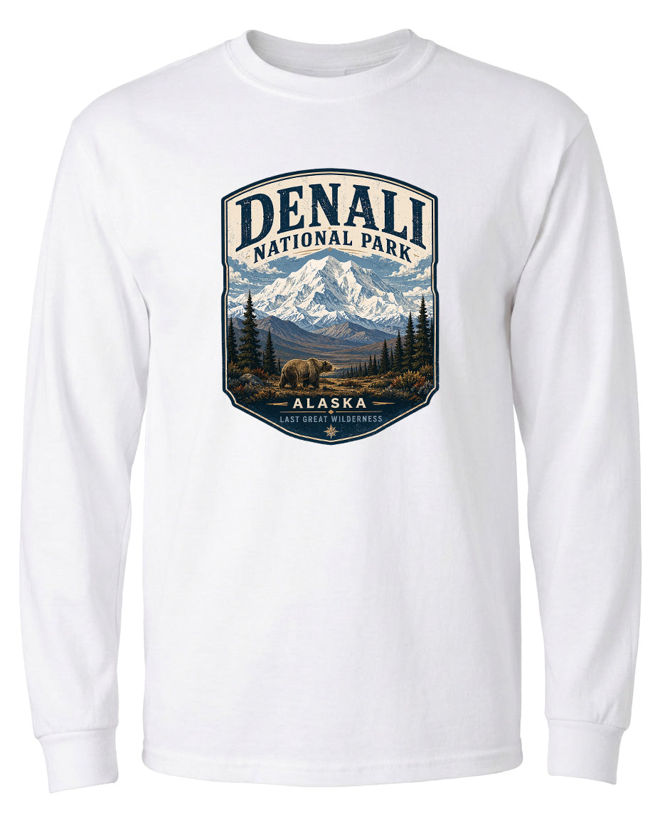 A white long-sleeved t-shirt with a graphic design depicting Denali National Park in Alaska, featuring a bear and a mountain landscape.
