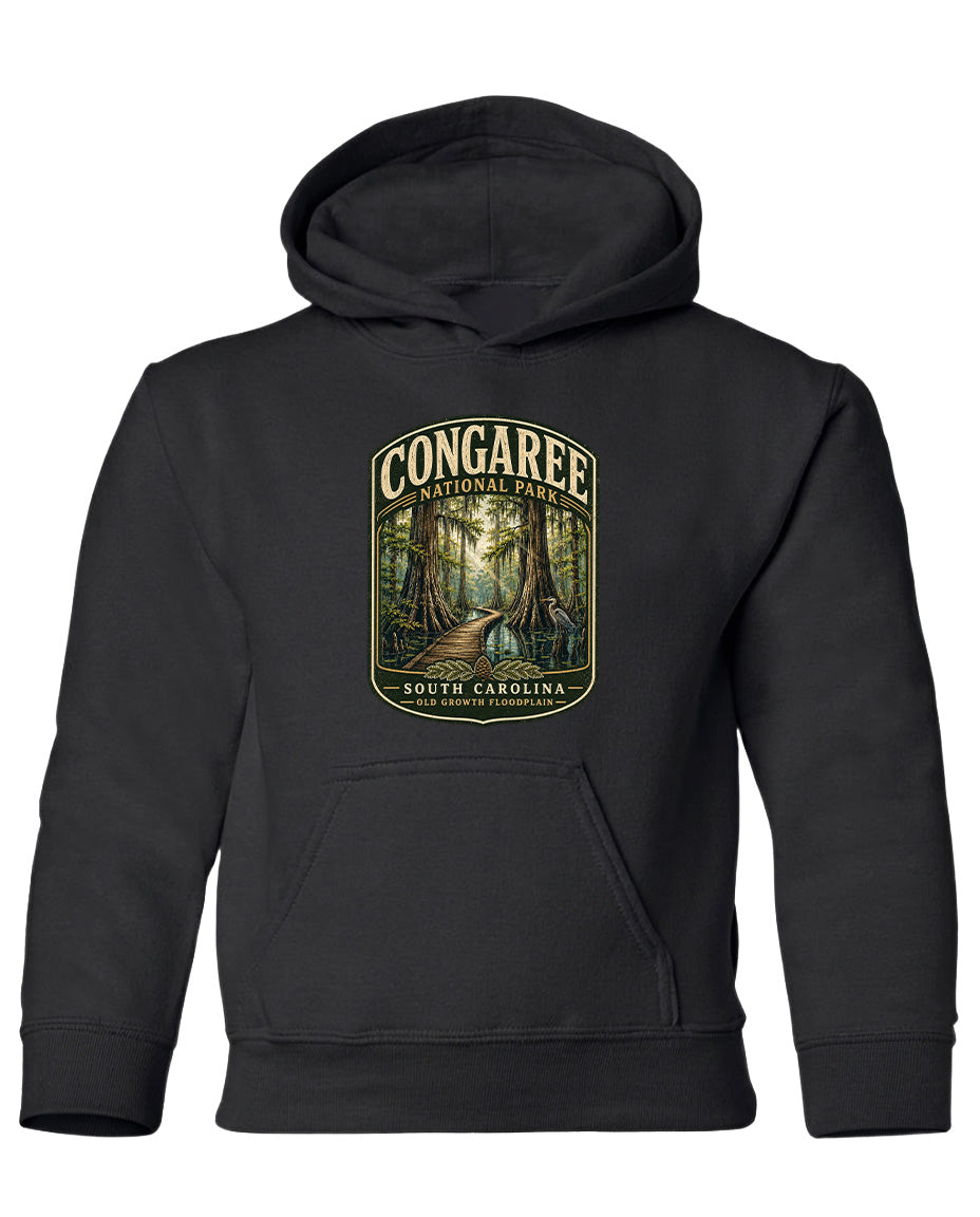 A black hooded sweatshirt with a graphic design depicting a forest scene and the text "CONGAREE NATIONAL PARK SOUTH CAROLINA" printed on it.
