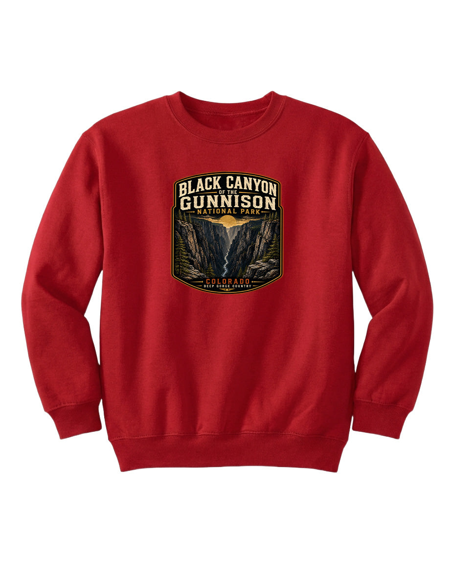 A red sweatshirt with a graphic design depicting the Black Canyon of the Gunnison National Park.