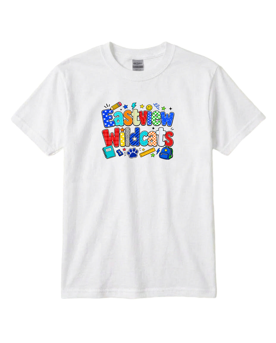 A white t-shirt with a colorful graphic design featuring the text "Eastview Wildcats" surrounded by various school-related icons and objects.