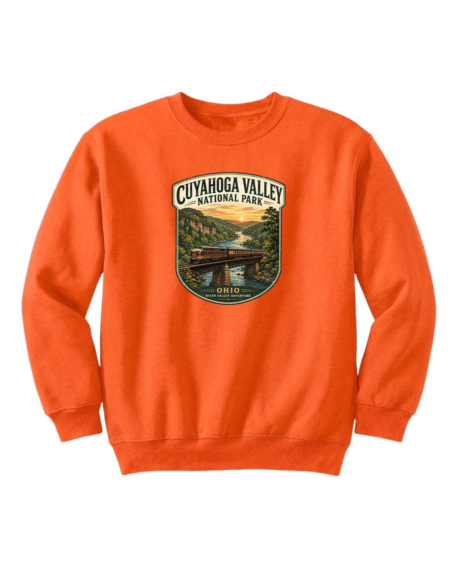 An orange sweatshirt with a graphic design depicting a scenic view of the Cuyahoga Valley National Park in Ohio.