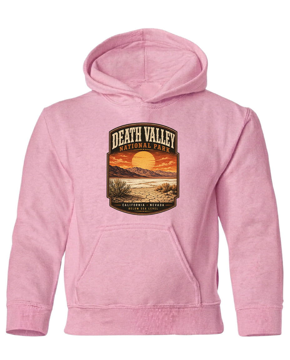 A pink hoodie with a graphic design depicting Death Valley National Park and a sunset landscape.