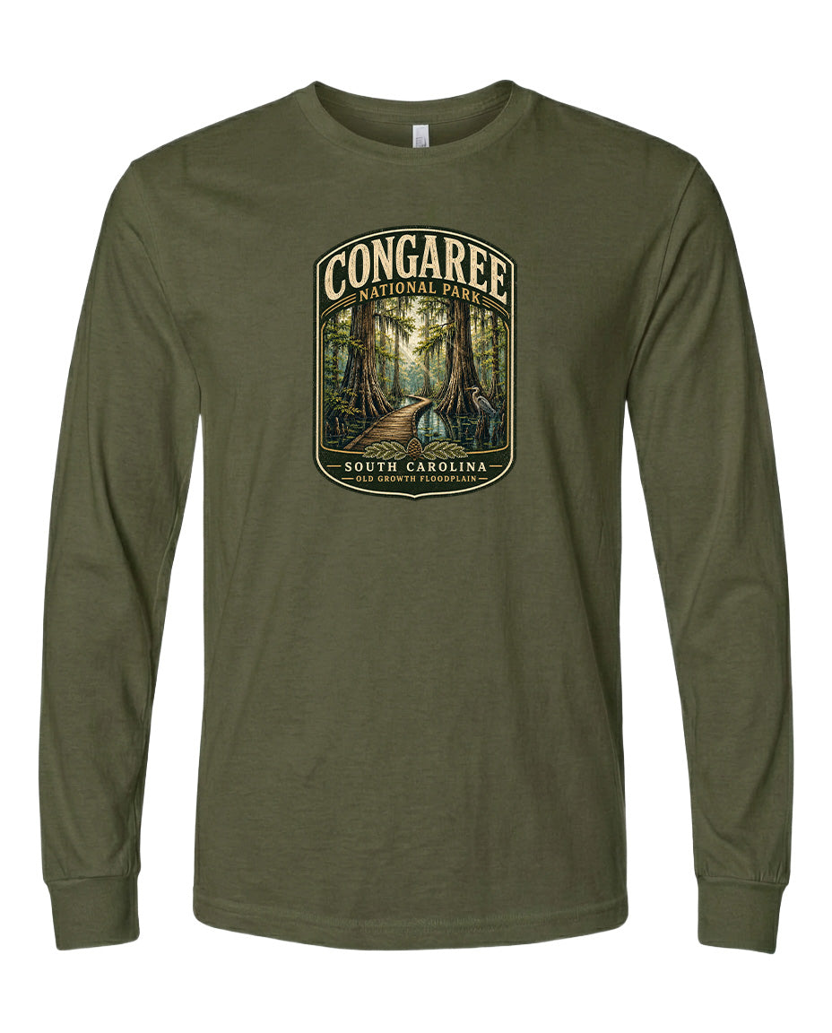 A green long-sleeved t-shirt with a graphic design depicting a forest scene, featuring a path leading through the trees.