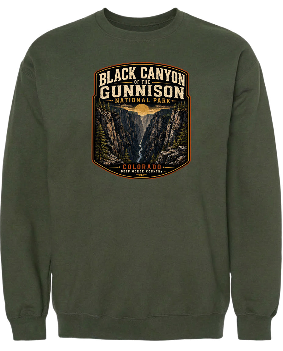 A green sweatshirt with a graphic design depicting the Black Canyon of the Gunnison National Park in Colorado.