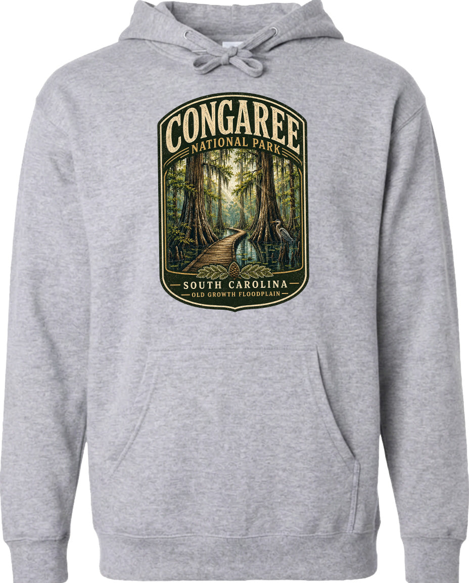 A gray hoodie with a graphic design depicting a forest scene, including a path leading through the trees and a bird in flight.