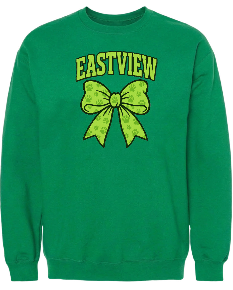 A green sweatshirt with a yellow bow and paw prints printed on it.