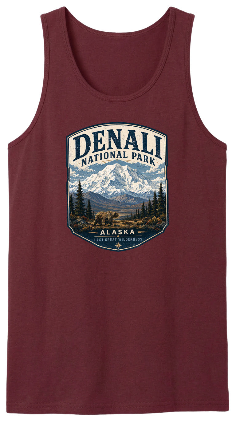 A red tank top with a graphic design depicting a mountain landscape with a bear in the foreground, surrounded by pine trees and mountains.