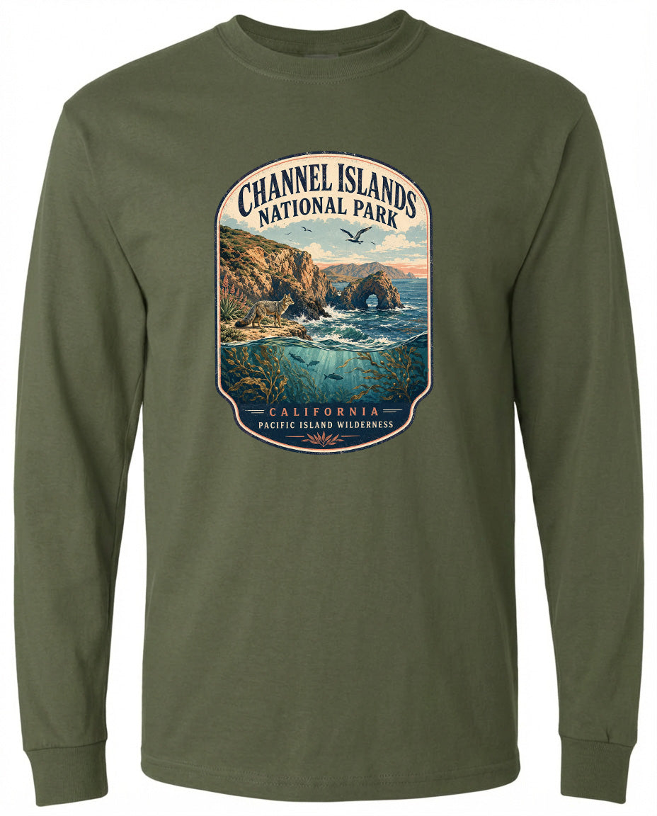 A graphic design on a long-sleeved green shirt depicting a scenic coastal landscape with cliffs, water, and a bird in flight.