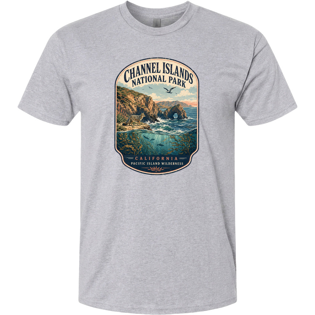 A gray t-shirt with a graphic design depicting a scenic coastal landscape with cliffs, water, and wildlife.