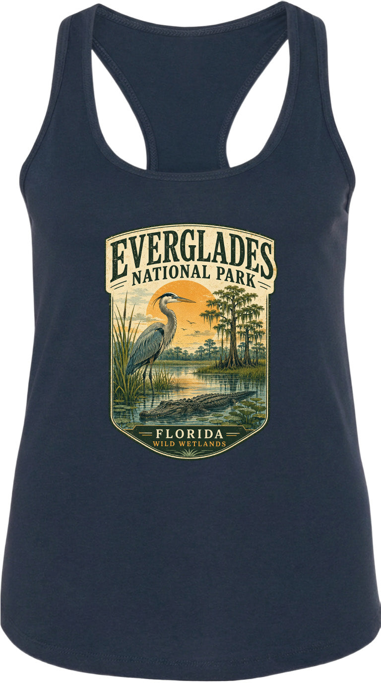 A navy blue tank top with a graphic design depicting a bird, a sunset, and a body of water, along with the text "EVERGLADES NATIONAL PARK FLORIDA WILDER".