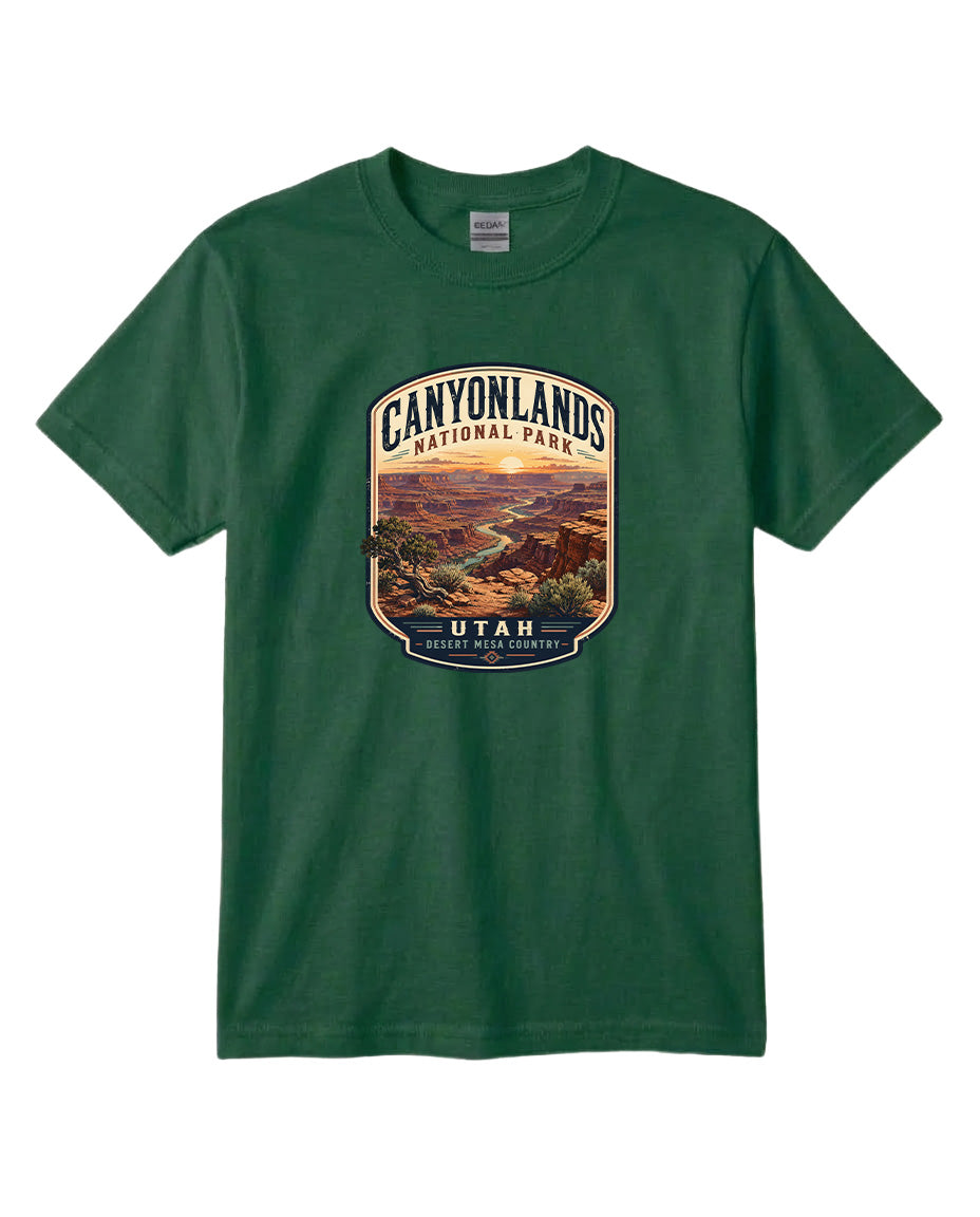 A green t-shirt with a graphic design depicting a scenic landscape, including mountains, a river, and a desert landscape, with the text "CANYONLANDS NATIONAL PARK UTAH DESERT MESERICA" printed on it.