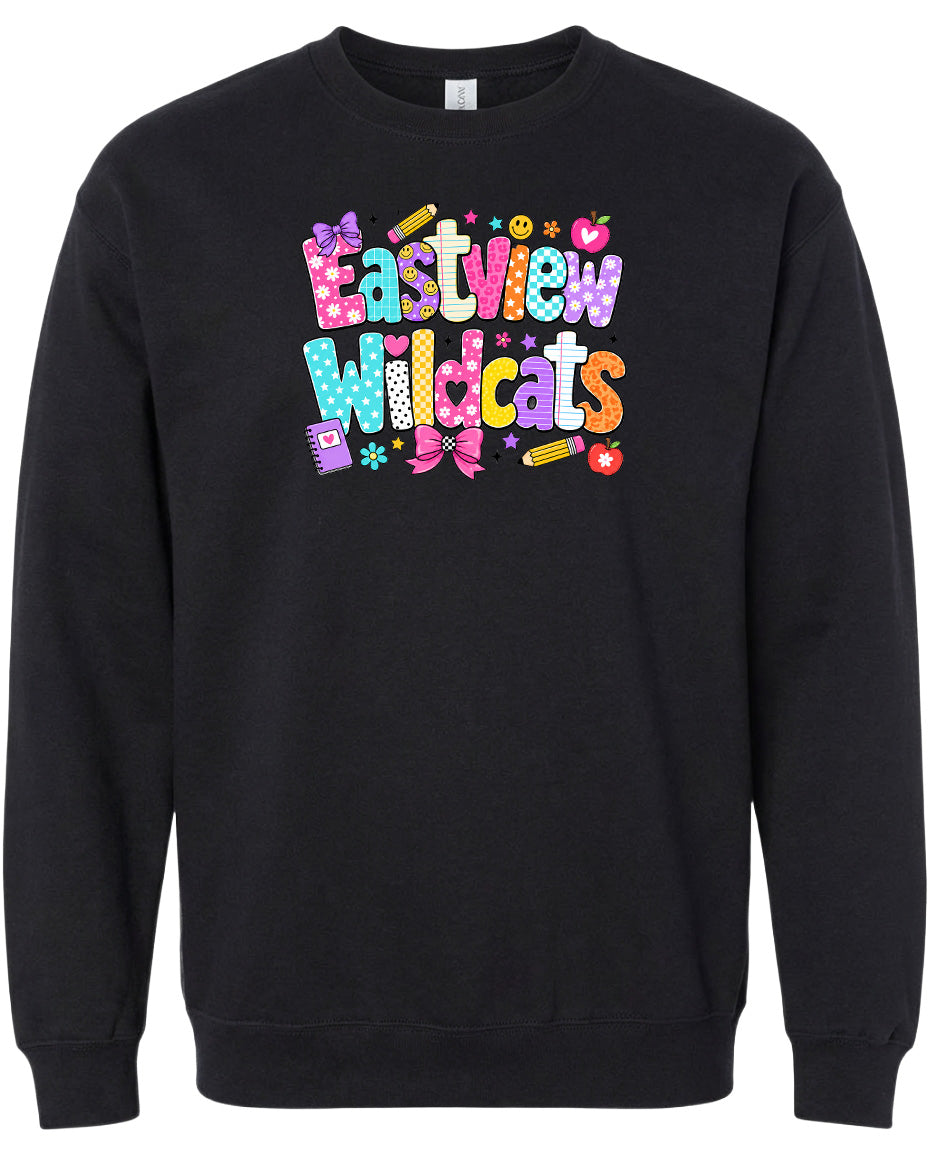 A black sweatshirt with a colorful, playful design featuring the text "Eastview Wildcats" and various decorative elements such as stars, hearts, and flowers.