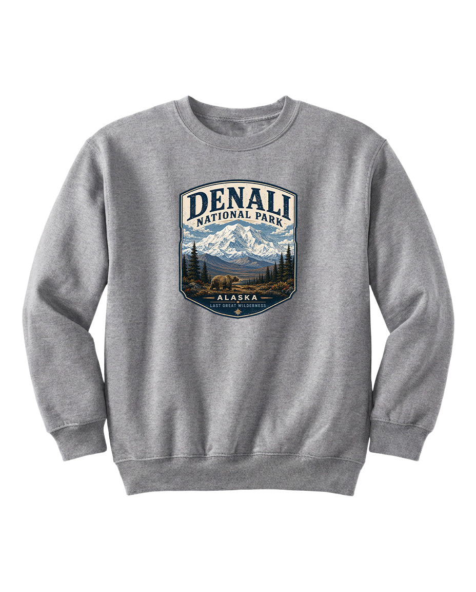A gray sweatshirt with a graphic design featuring a mountain landscape and a bear.