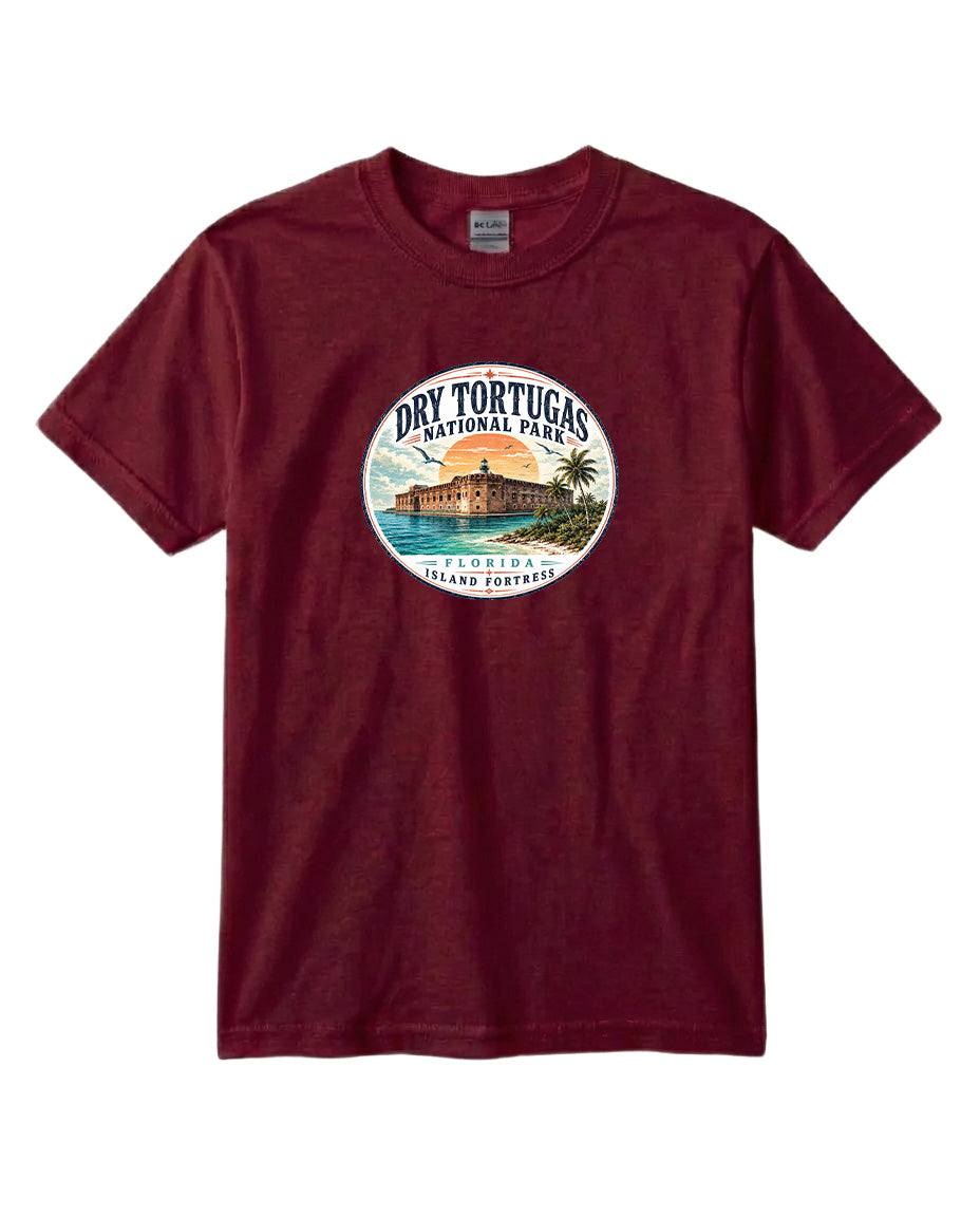 A burgundy-colored t-shirt with a circular graphic design featuring a tropical beach scene and a building.