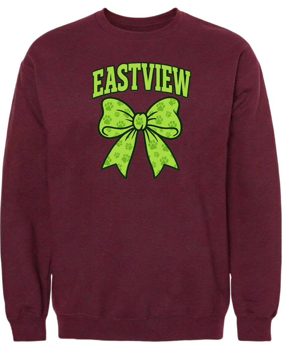 A burgundy sweatshirt with a green bow and paw prints printed on it.