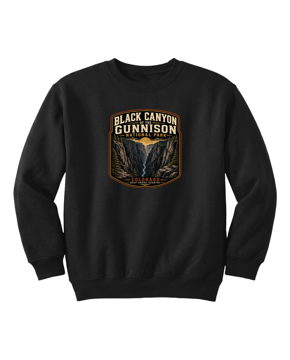 A black sweatshirt with a graphic design featuring the text "Black Canyon Gunnison National Park" and an illustration of the Black Canyon in the Colorado Plateau.