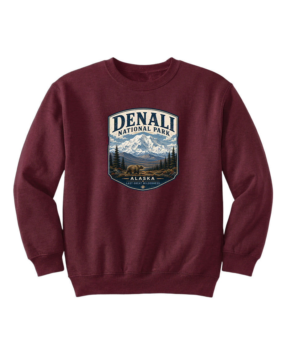 A burgundy sweatshirt with a graphic design featuring a mountain landscape and bears, representing Denali National Park in Alaska.