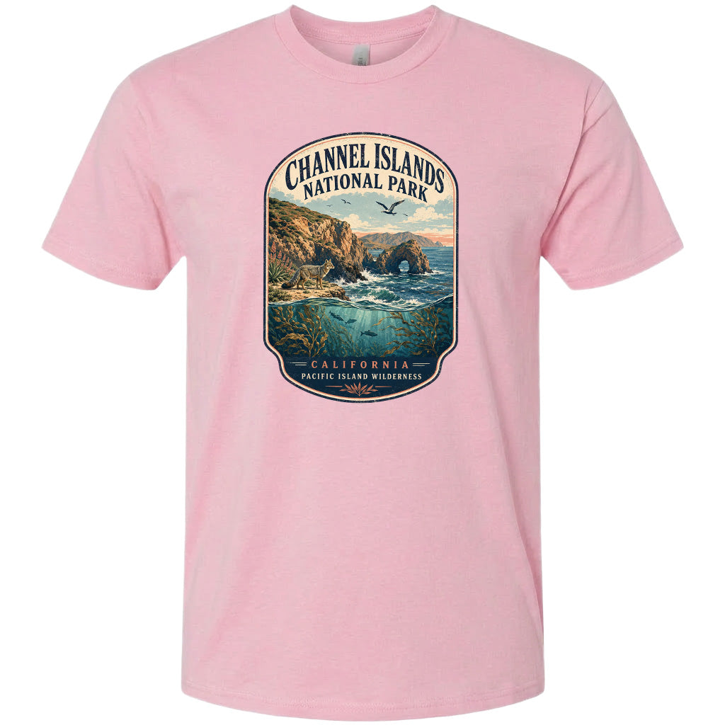 A pink t-shirt with a graphic design depicting a scenic coastal landscape with cliffs, water, and wildlife.