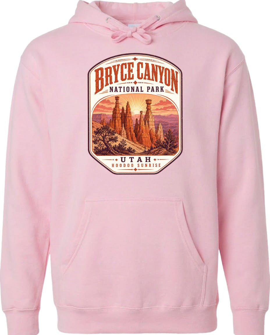 A pink hoodie with a graphic design depicting Bryce Canyon National Park and Utah.