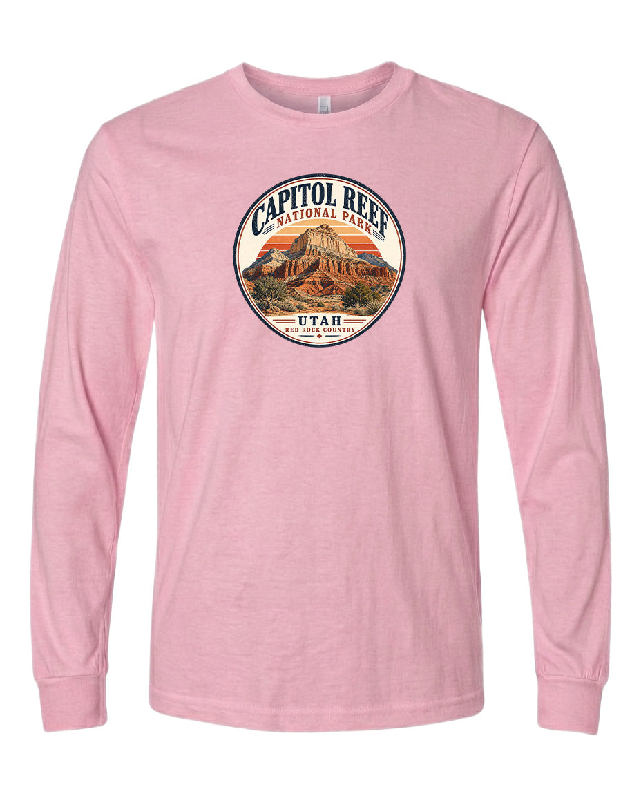 A pink long-sleeved t-shirt with a circular graphic design featuring the Capitol Reef National Park in Utah.