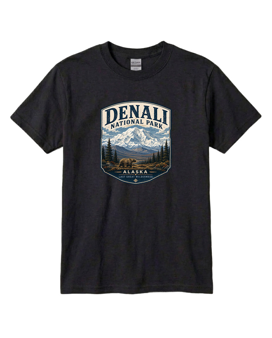 A black t-shirt with a graphic design depicting a mountain landscape with a bear, surrounded by text that says "DENALI NATIONAL PARK ALASKA LAST GREAT WILDERNESS".