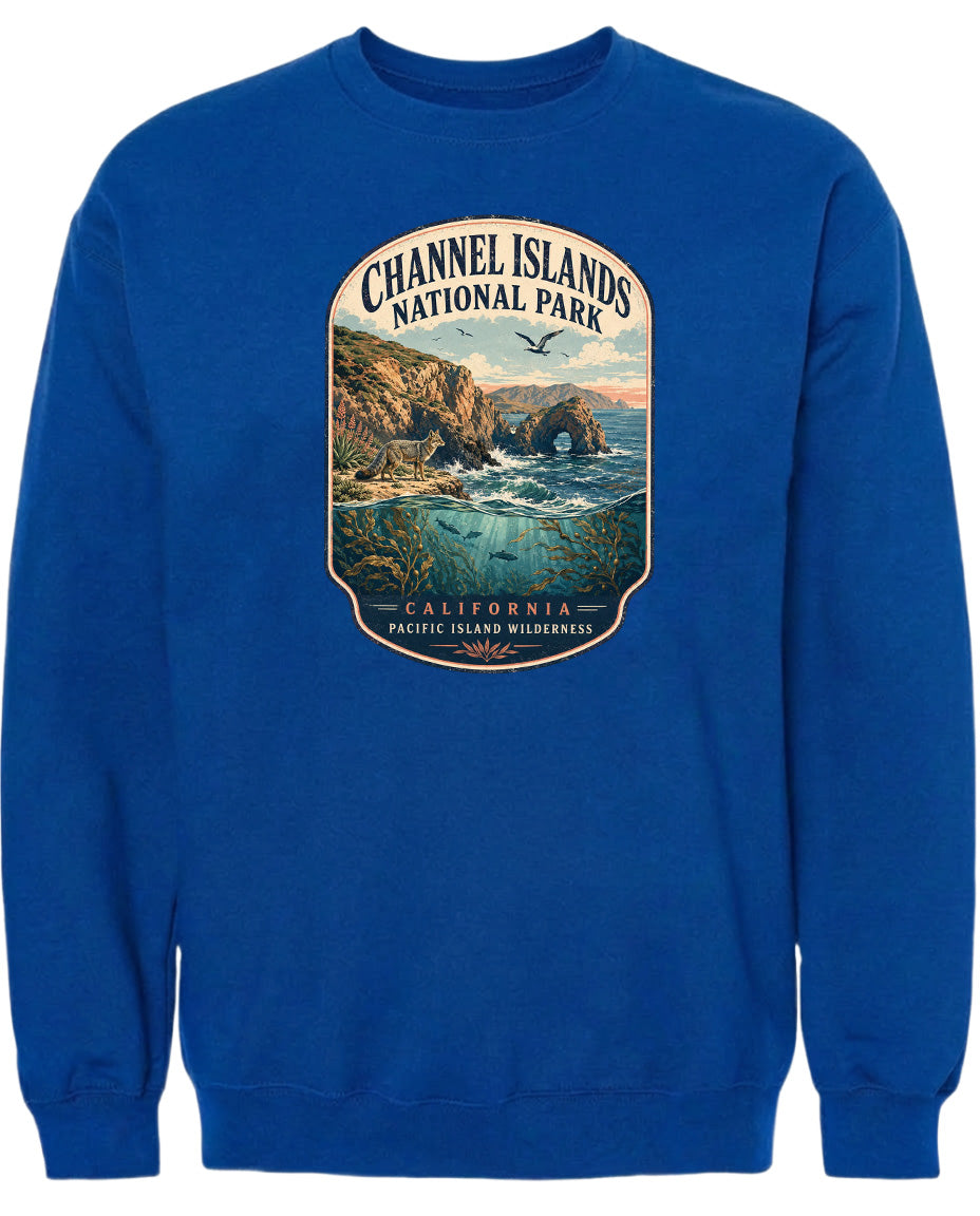 A blue sweatshirt with a graphic design depicting a scenic landscape with cliffs, water, and birds.