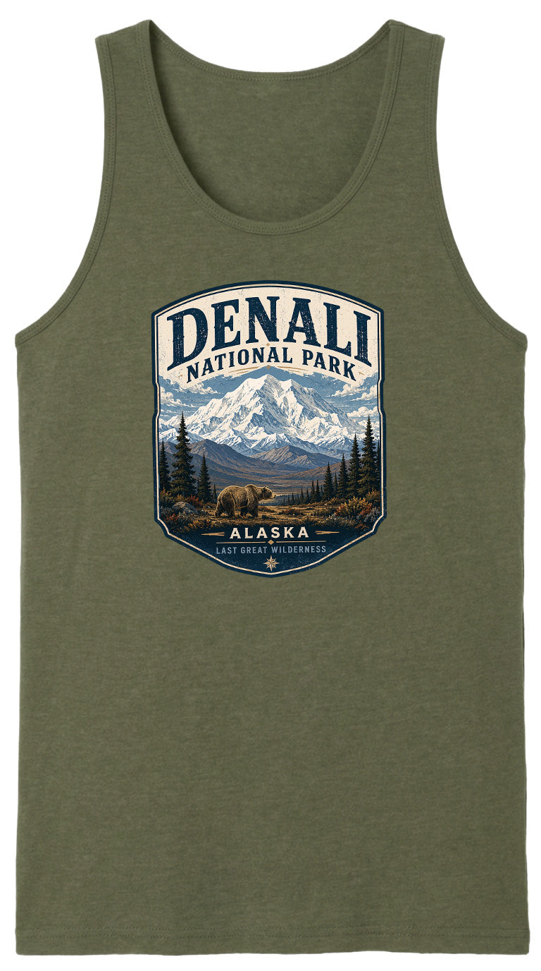 A green tank top with a graphic design depicting a bear in Alaska National Park, surrounded by mountains and pine trees.