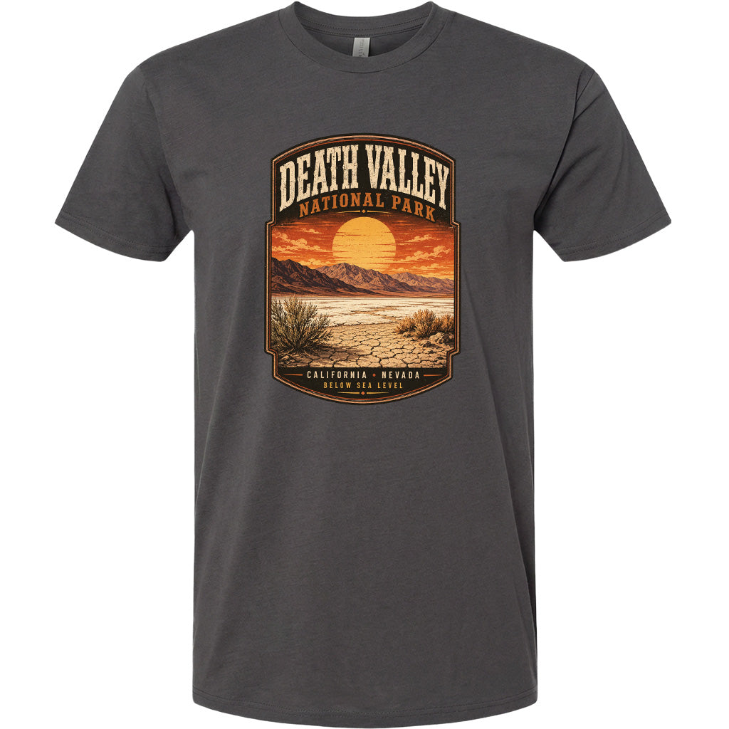 A graphic t-shirt design featuring a desert landscape with mountains, a sunset, and the text "DEATH VALLEY NATIONAL PARK CALIFORNIA NEVADA BELOW SEA LEVEL".