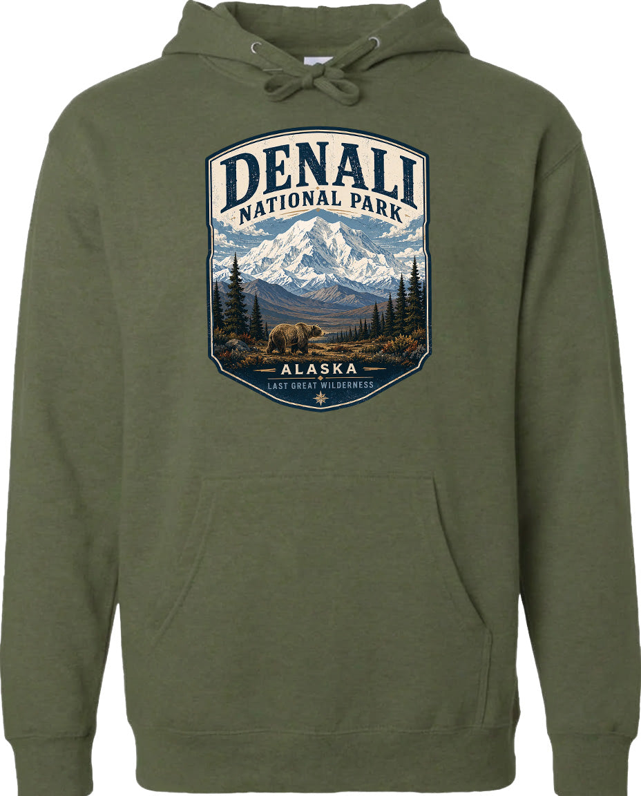 A hoodie with a graphic design featuring a mountain landscape and a bear, with the text "DENALI NATIONAL PARK ALASKA" prominently displayed.