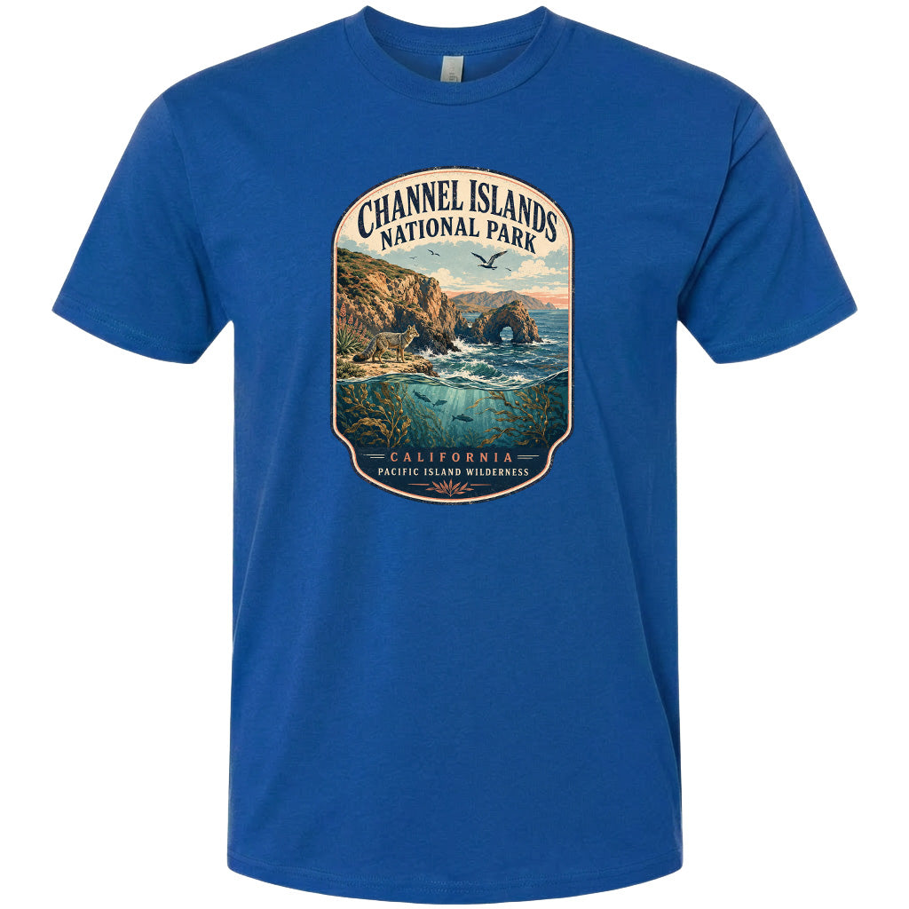 A blue t-shirt with a graphic design depicting a scenic coastal landscape with cliffs, water, and wildlife.