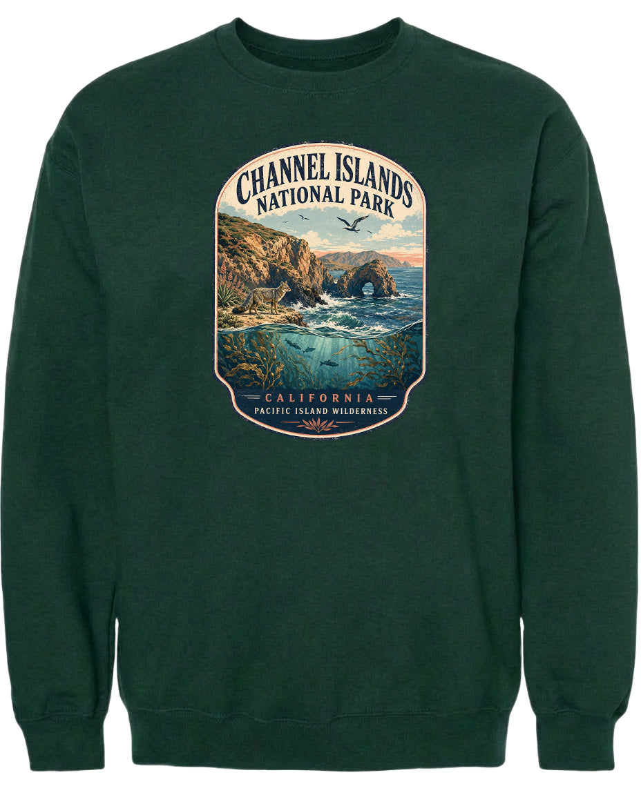 A green sweatshirt with a graphic design depicting a scenic landscape with cliffs, water, and a bird in flight.