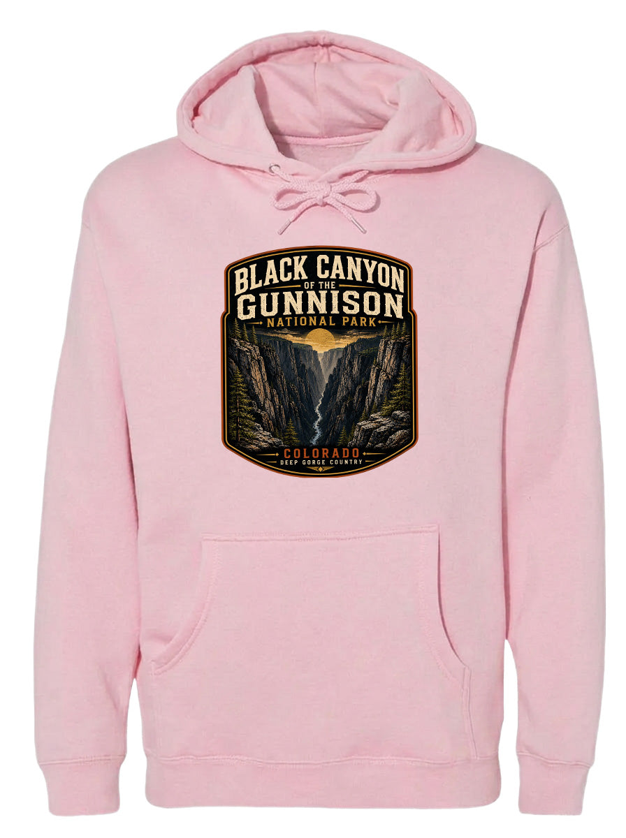 A pink hoodie with a graphic design depicting the Black Canyon of the Gunnison National Park in Colorado.