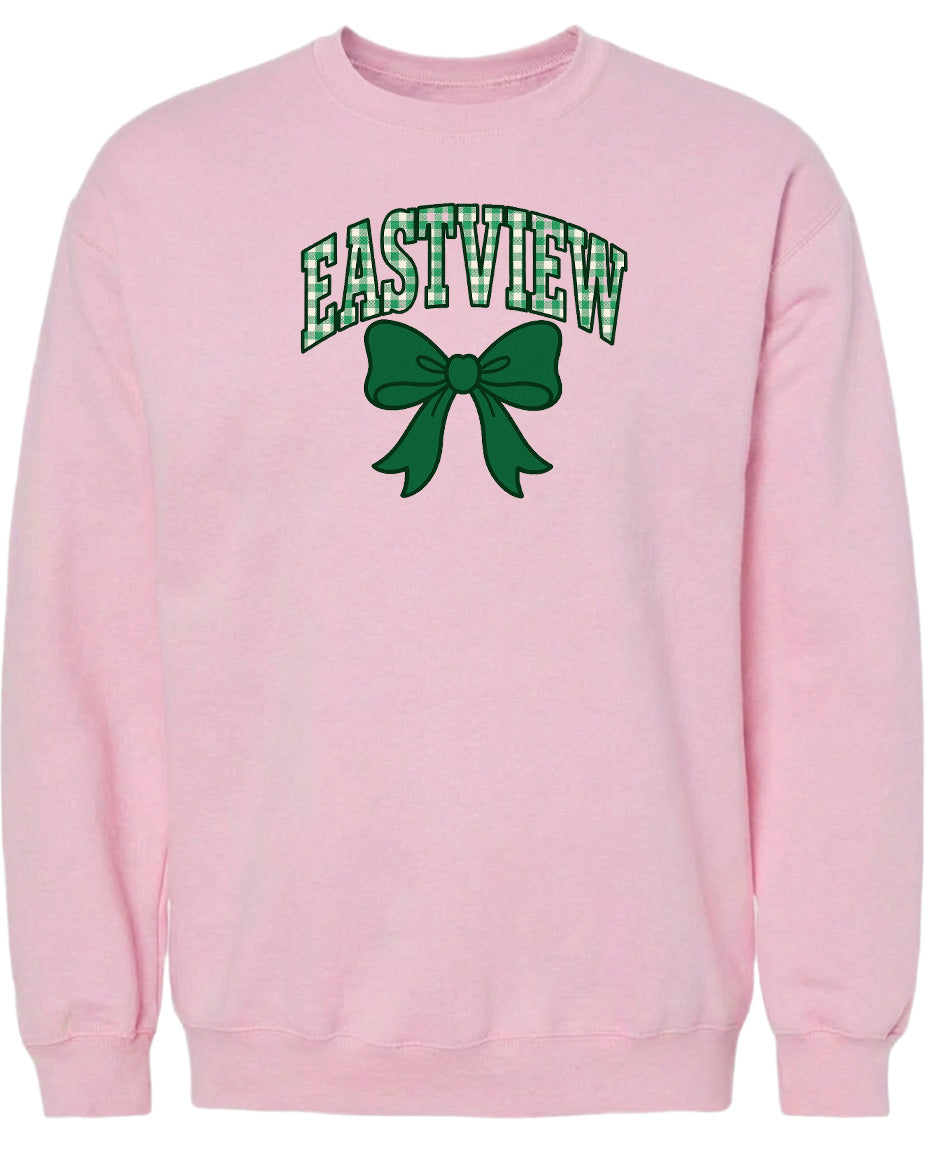 A pink sweatshirt with the word "EASTVIEW" and a green bow printed on it.