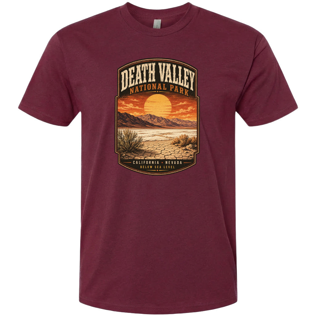 A t-shirt design featuring a desert landscape with mountains, a sunset, and a label that reads "DEATH VALLEY NATIONAL PARK CALIFORNIA - NEVADA BELOW SEA LEVEL".