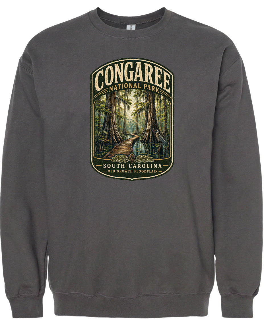 A gray sweatshirt with a graphic design depicting a forest scene with a path leading through it, surrounded by trees and foliage.