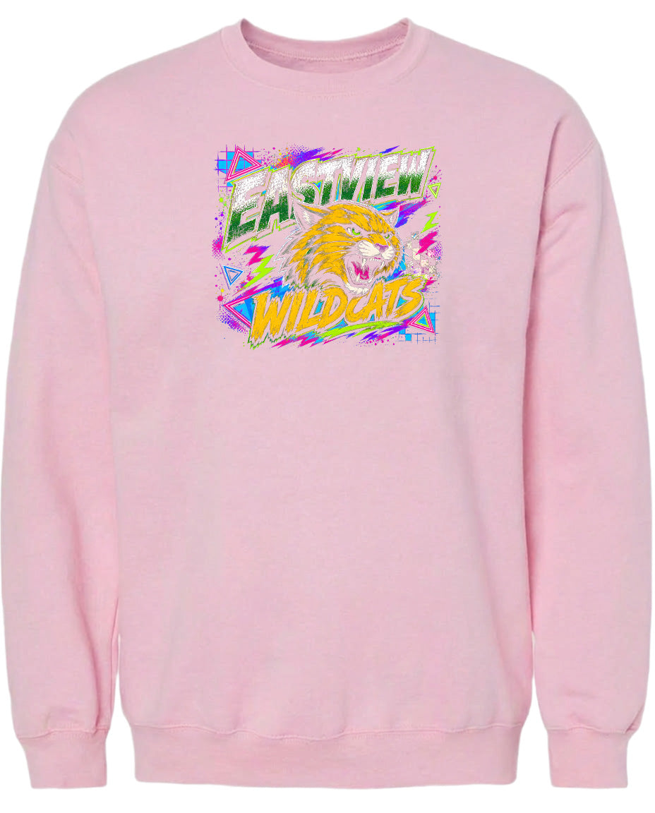 A pink sweatshirt with a graphic design featuring a yellow and orange cat with a fierce expression, surrounded by colorful geometric shapes and text.